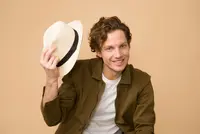 Man With A Hat Smiling Before Upscale