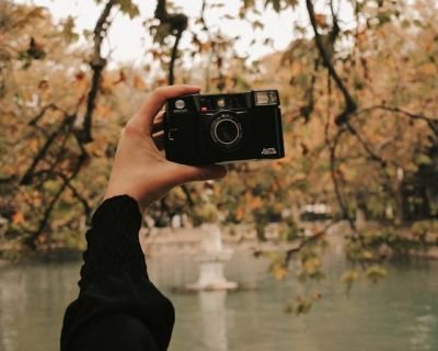Person Holding a Black Camera