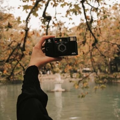 Person Holding a Black Camera